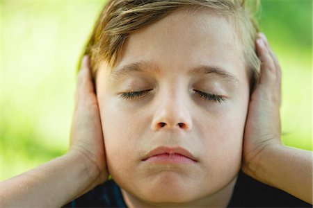 silence - Boy covering ears with hands, eyes closed Stock Photo - Premium Royalty-Free, Code: 632-06118234