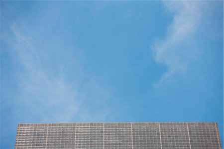 Building facade and blue sky, low angle view Stock Photo - Premium Royalty-Free, Code: 632-06118510