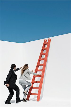 reaching - Executives racing each other to climb ladder Stock Photo - Premium Royalty-Free, Code: 632-06118611