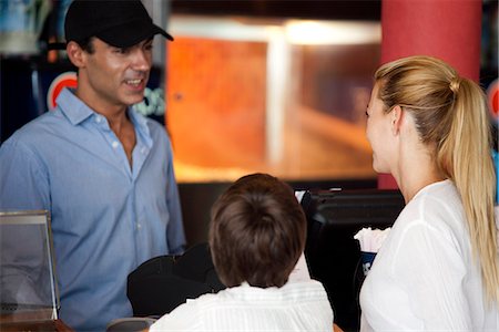restaurant counter - Mother and son ordering food at counter, rear view Stock Photo - Premium Royalty-Free, Code: 632-06118803