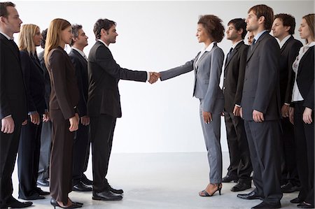 full length standing - Business leaders shaking hands in agreeement Stock Photo - Premium Royalty-Free, Code: 632-06118936