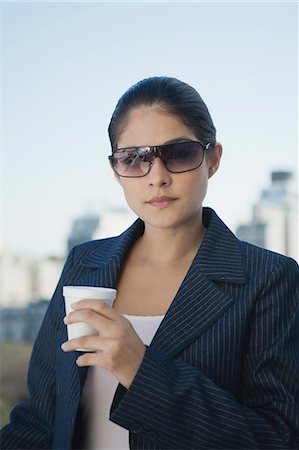 simsearch:632-08130128,k - Young businesswoman holding disposable cup Stock Photo - Premium Royalty-Free, Code: 632-06317102