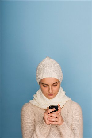 Young woman text messaging with cell phone Stock Photo - Premium Royalty-Free, Code: 632-06317197