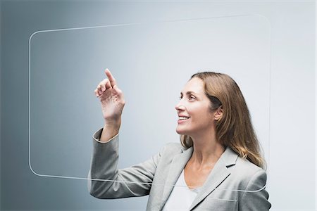 finger print - Businesswoman using large transparent touch screen Stock Photo - Premium Royalty-Free, Code: 632-06317428