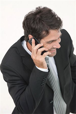 simsearch:632-05400935,k - Businessman talking on cell phone, elevated view Stock Photo - Premium Royalty-Free, Code: 632-06317477