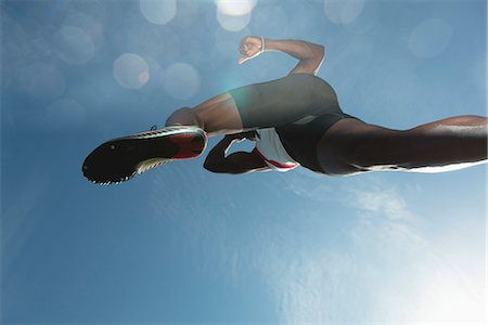 Athlete in midair, low angle view Stock Photo - Premium Royalty-Free, Code: 632-06317539