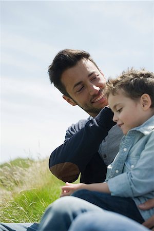 simsearch:632-03848361,k - Father caressing son's hair outdoors Stock Photo - Premium Royalty-Free, Code: 632-06317571