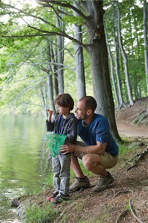 fishing family - Father and son fishing, boy staring at tiny fish in hand Stock Photo - Premium Royalty-Free, Code: 632-06317767