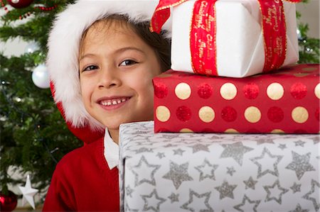 pile of christmas gifts - Boy with stack of Christmas presents, portrait Stock Photo - Premium Royalty-Free, Code: 632-06354142