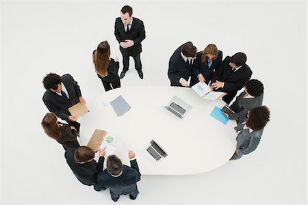 Business associates working together in groups around table Stock Photo - Premium Royalty-Free, Code: 632-06354166