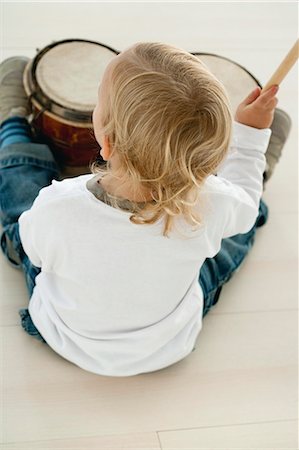 drum (instrument) - Baby boy playing drums, rear view Stock Photo - Premium Royalty-Free, Code: 632-06354175