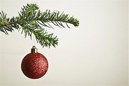 Red Christmas bauble hanging from Christmas tree Stock Photo - Premium Royalty-Free, Code: 632-06354204