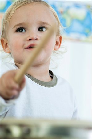 rhythm - Baby boy playing drum, low angle view Stock Photo - Premium Royalty-Free, Code: 632-06354217