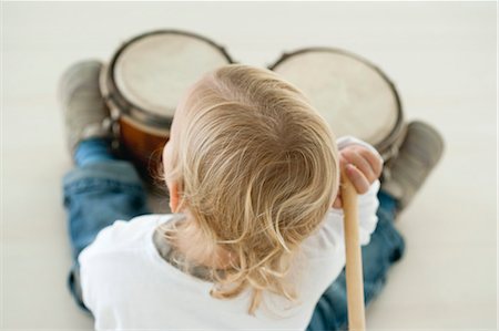 drum (instrument) - Baby boy playing drums, rear view Stock Photo - Premium Royalty-Free, Code: 632-06354285