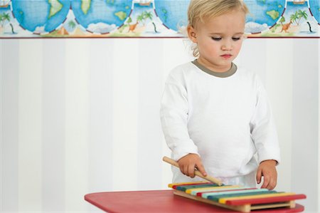 Baby boy playing toy xylophone Stock Photo - Premium Royalty-Free, Code: 632-06354304