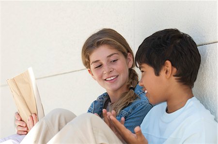 simsearch:632-06029740,k - Preteen girl and boy sitting together outdoors Stock Photo - Premium Royalty-Free, Code: 632-06404233