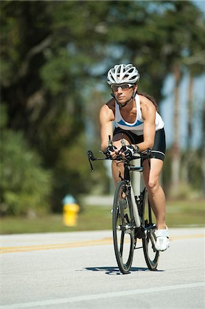 road cycling - Female cyclist riding on road Stock Photo - Premium Royalty-Free, Code: 632-06404307