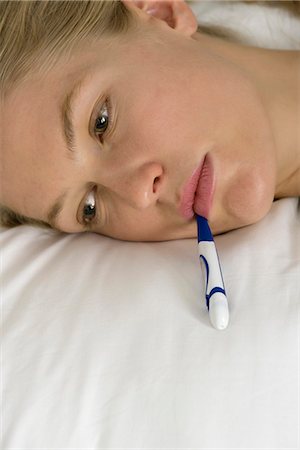 Young woman with thermometer in mouth, cropped Stock Photo - Premium Royalty-Free, Code: 632-06404518