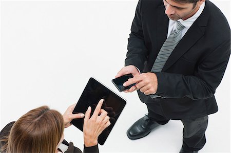 exchanging - Businesswoman using digital tablet, businessman using smartphone Stock Photo - Premium Royalty-Free, Code: 632-06404569