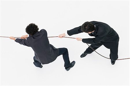 Businessmen playing tug-of-war Foto de stock - Sin royalties Premium, Código: 632-06404590