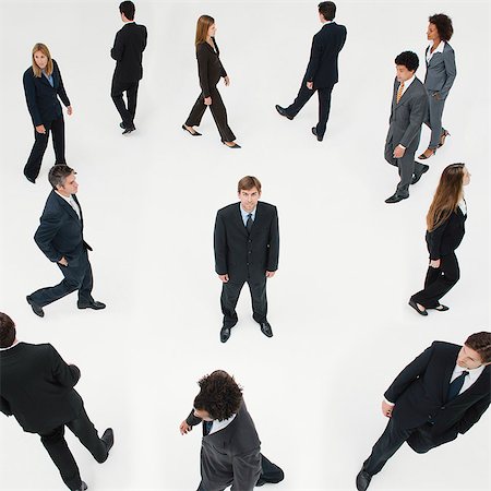 standing concept individuality concept - Businessman standing still in midst of other business professionals on the move Stock Photo - Premium Royalty-Free, Code: 632-06404617