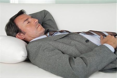 Mature businessman sleeping on couch Stock Photo - Premium Royalty-Free, Code: 632-06779257