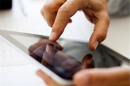 fingers holding - Man using touch screen on digital tablet, cropped Stock Photo - Premium Royalty-Free, Code: 632-06967673