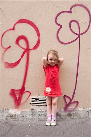 flower girl - Little girl leaning against wall with flower graffiti, portrait Stock Photo - Premium Royalty-Free, Code: 632-06967692