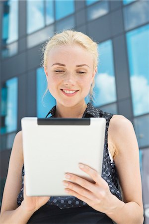simsearch:632-07161246,k - Young woman using digital tablet outdoors Stock Photo - Premium Royalty-Free, Code: 632-07161245