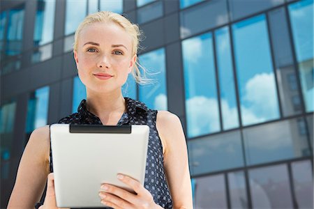 simsearch:632-07161246,k - Young businesswoman using digital tablet outdoors Stock Photo - Premium Royalty-Free, Code: 632-07161247