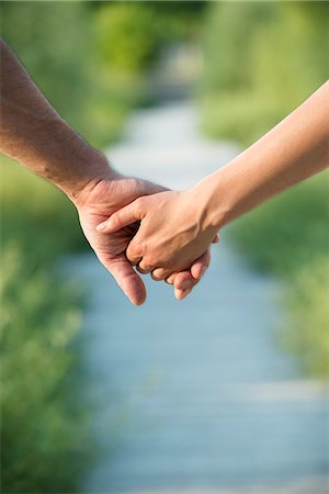 romantic couple holding hands - Couple holding hands, close-up Stock Photo - Premium Royalty-Free, Code: 632-07161278