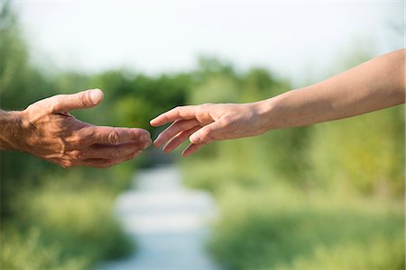 reaching - Man and woman reaching out to shake hands Stock Photo - Premium Royalty-Free, Code: 632-07161281