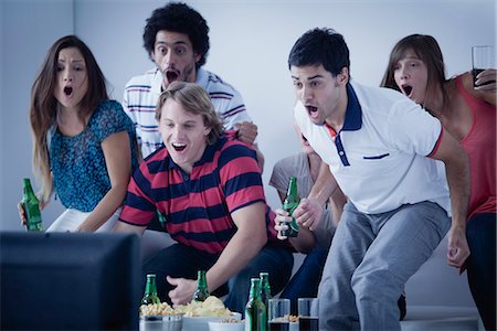 Friends watching exciting sports match on television together Stock Photo - Premium Royalty-Free, Code: 632-07161297