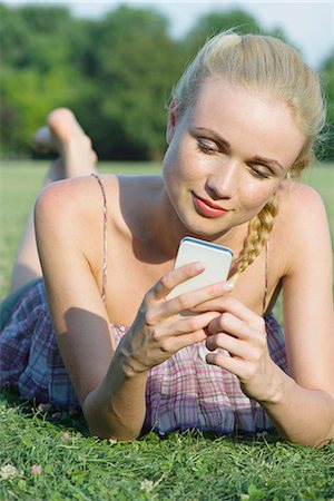 simsearch:632-07161246,k - Woman lying on grass, using smartphone Stock Photo - Premium Royalty-Free, Code: 632-07161306