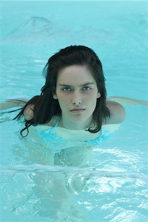 Woman in swimming pool, looking at camera Stock Photo - Premium Royalty-Free, Code: 632-07161413