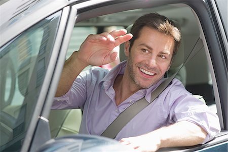 driver (vehicle, male) - Man driving car, smiling out window and waving Stock Photo - Premium Royalty-Free, Code: 632-07161433