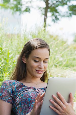simsearch:632-07161246,k - Woman using digital tablet outdoors Stock Photo - Premium Royalty-Free, Code: 632-07161529