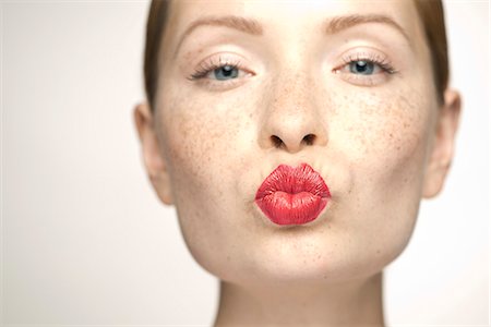 Young woman puckering lips, portrait Stock Photo - Premium Royalty-Free, Code: 632-07494974