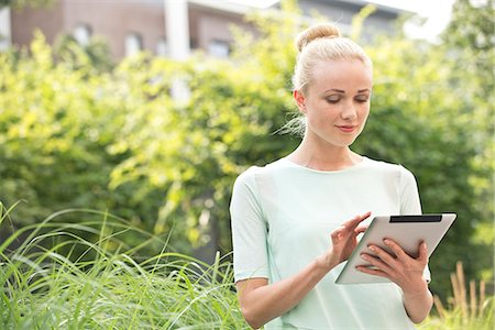 simsearch:632-07161246,k - Young woman using digital tablet outdoors Stock Photo - Premium Royalty-Free, Code: 632-07495092