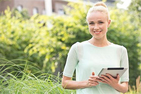 simsearch:632-07161246,k - Young woman using digital tablet outdoors Stock Photo - Premium Royalty-Free, Code: 632-07495093