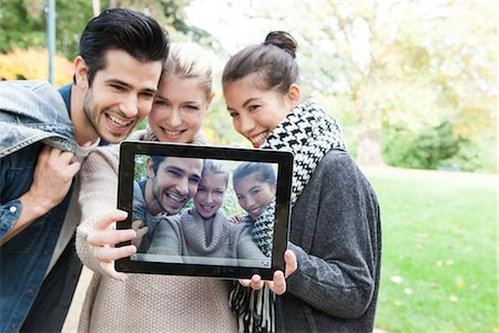 selfie - Friends photographing themselves with digital tablet outdoors Stock Photo - Premium Royalty-Free, Code: 632-07539914