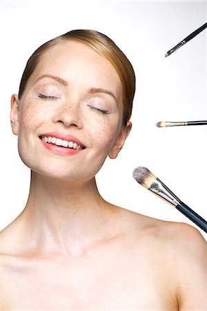 simsearch:693-06022101,k - Young woman with make-up brushes Stock Photo - Premium Royalty-Free, Code: 632-07539964