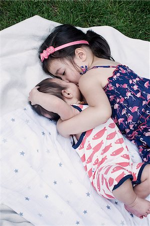 sister brother hugging two - Little girl with baby brother lying on blanket outdoors Stock Photo - Premium Royalty-Free, Code: 632-07674573