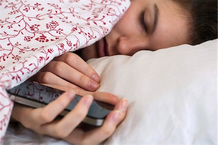 sleepy - Woman sleeping in bed with smartphone in hand Stock Photo - Premium Royalty-Free, Code: 632-07674614
