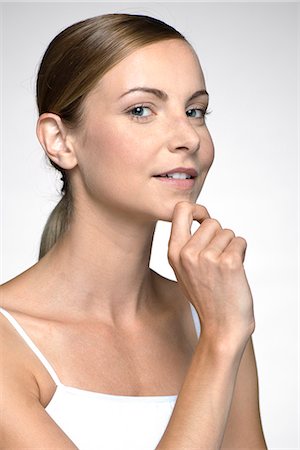 Young woman with hand under chin Stock Photo - Premium Royalty-Free, Code: 632-07674772