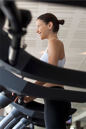 Woman using treadmill in health club Stock Photo - Premium Royalty-Free, Code: 632-07809434
