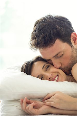 Couple sharing intimate moment together in bed Stock Photo - Premium Royalty-Free, Code: 632-07809521