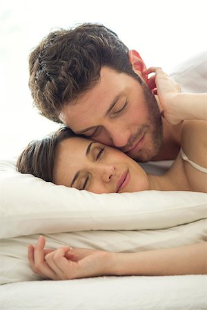 Couple cuddling together in bed Stock Photo - Premium Royalty-Free, Code: 632-07809522