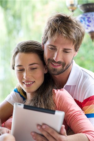 Young couple using digital tablet together outdoors Stock Photo - Premium Royalty-Free, Code: 632-07849457