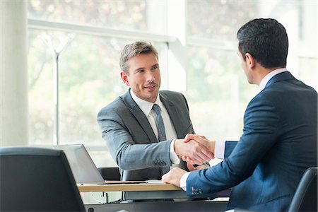 financial advisor - Businessmen shaking hands in meeting Stock Photo - Premium Royalty-Free, Code: 632-08001603